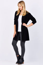 Model Phoebe wearing size 10 of the Merino Long Cardigan in colour Black (Black), from the front, showing the whole outfit