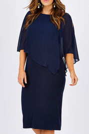 Model Laura wearing size 12 of the Cassandra Dress in colour Navy (Blue), from the front, cropped image