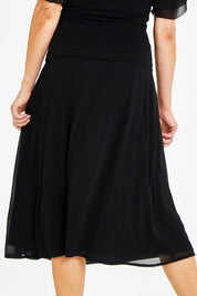 Model Naomi wearing size 10 of the Gia Skirt in colour Black (Black), from the back