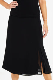 Model Naomi wearing size 10 of the Gia Skirt in colour Black (Black), from the front, cropped image