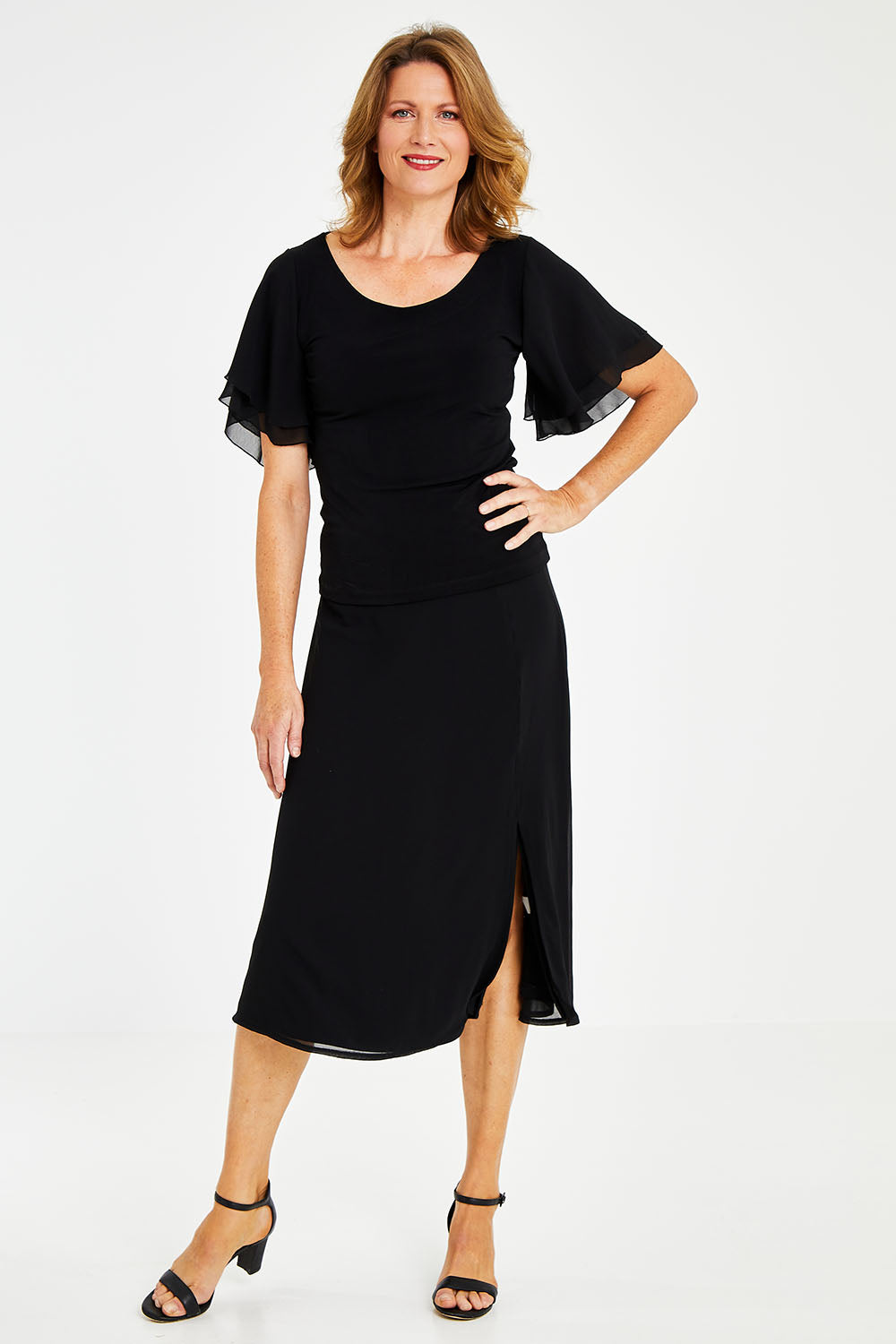 Model Naomi wearing size 10 of the Gia Skirt in colour Black (Black), from the front, showing the whole outfit