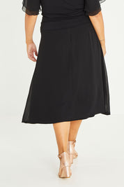 Model Palatina wearing size 16 of the Gia Skirt in colour Black (Black), from the back