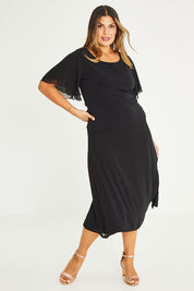 Model Palatina wearing size 16 of the Gia Skirt in colour Black (Black), from the front, showing the whole outfit