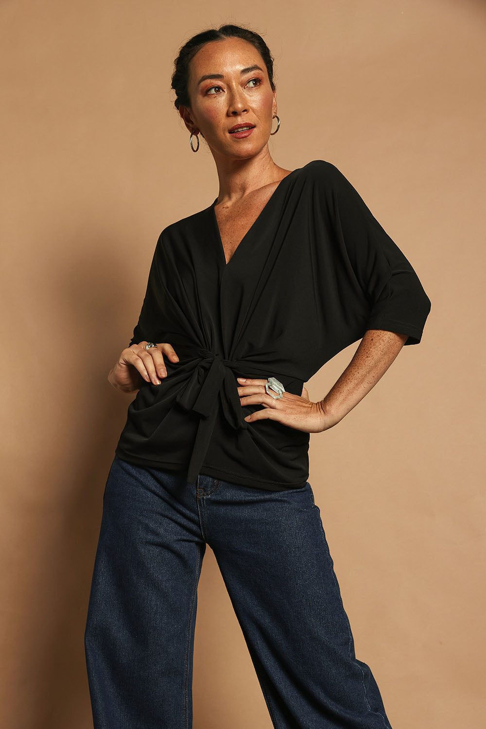 Model Katie wearing size 10 of the Niamh Top in colour Black (Black), from the front, showing the whole outfit