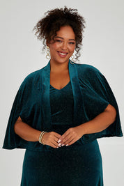 Model Alexis wearing size 16 of the Lynette Velvet Cape in colour Jade (Green), from the front, cropped image