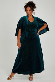 Model Alexis wearing size 16 of the Lynette Velvet Cape in colour Jade (Green), from the front, showing the whole outfit