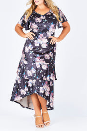 Model Fiona wearing size 16 of the Rebecca Dress in colour WinterRose (Black), from the front, cropped image