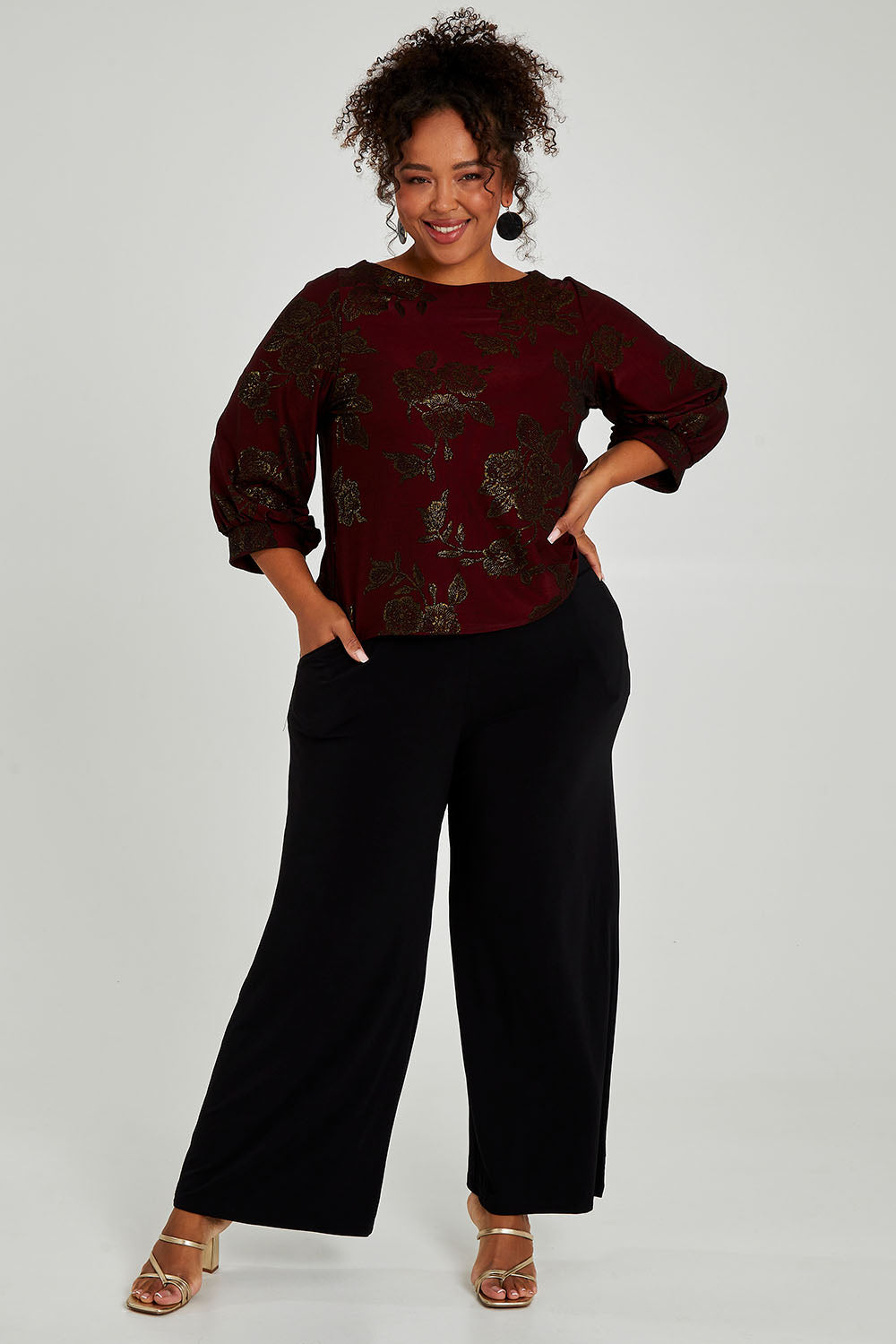 Model Alexis wearing size 18 of the Kristi Pants in colour Black (Black), from the front, showing the whole outfit