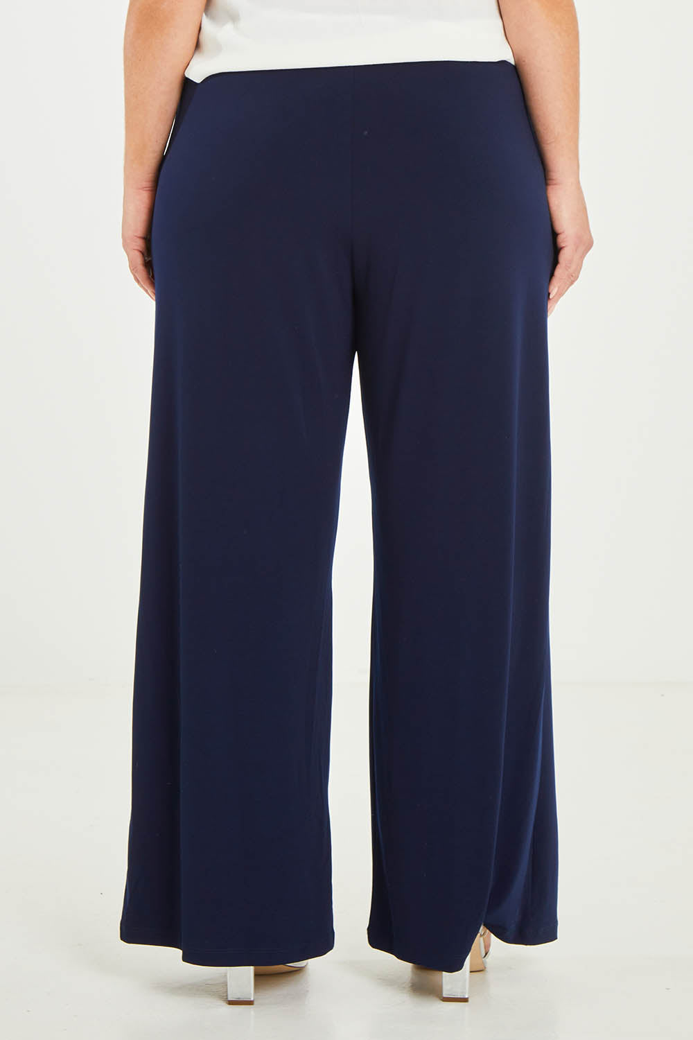 Model Katie wearing size 16 of the Kristi Pants in colour Navy (Blue), from the back