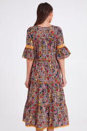 Model Madeline wearing size S of the Avlon Midi in colour Beatrix (Black), from the back