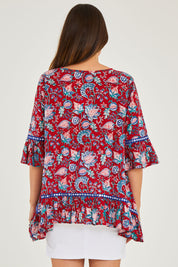 Model Georgia wearing size S of the Hacienda Tunic in colour Novellared (Red), from the back