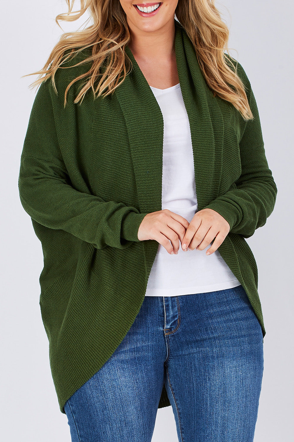 Model Jess wearing size M of the Natural Cocoon Cardigan in colour Vineyard (Green), from the front, cropped image