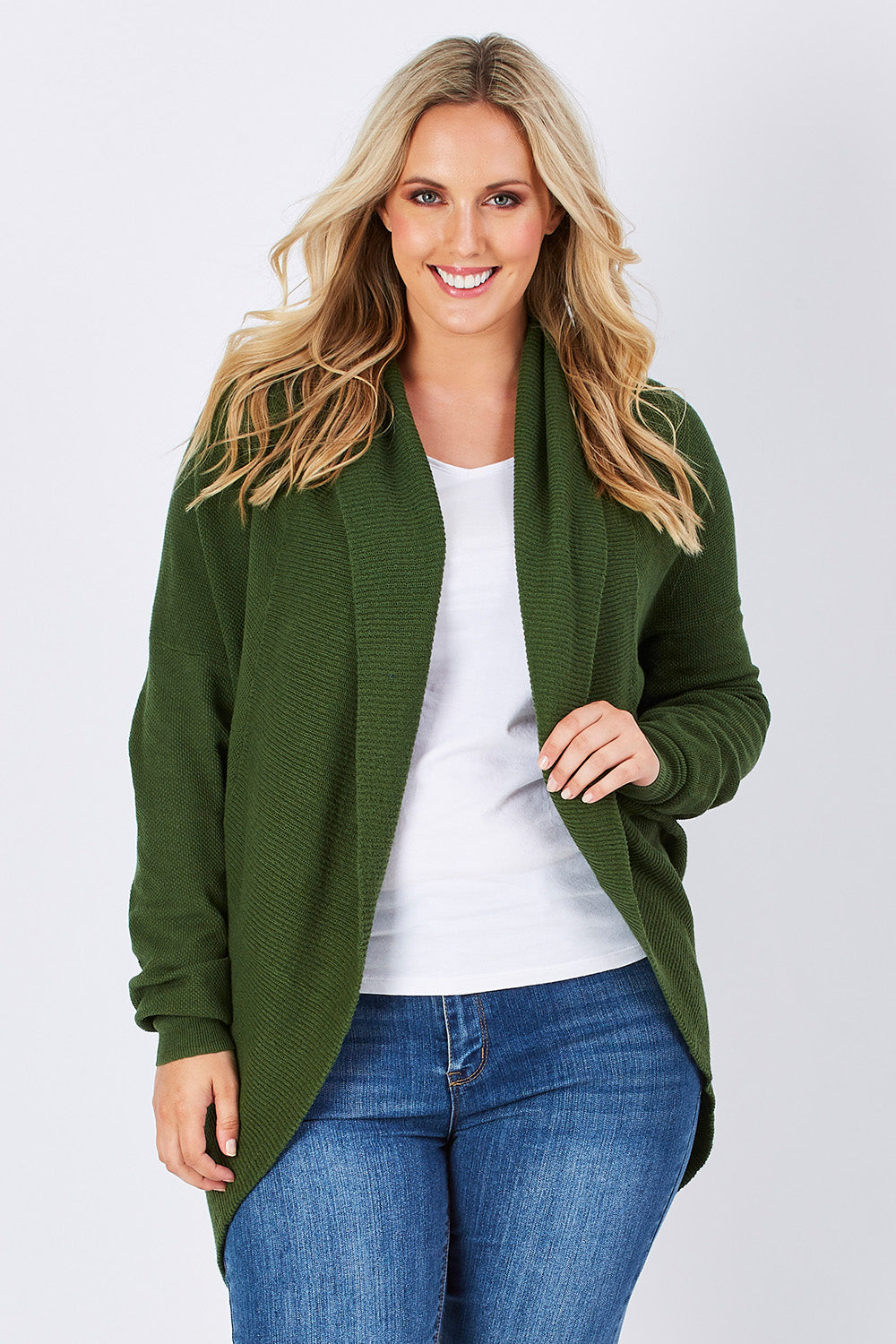 Model Perrie wearing size M of the Natural Cocoon Cardigan in colour Vineyard (Green), from the front, cropped image