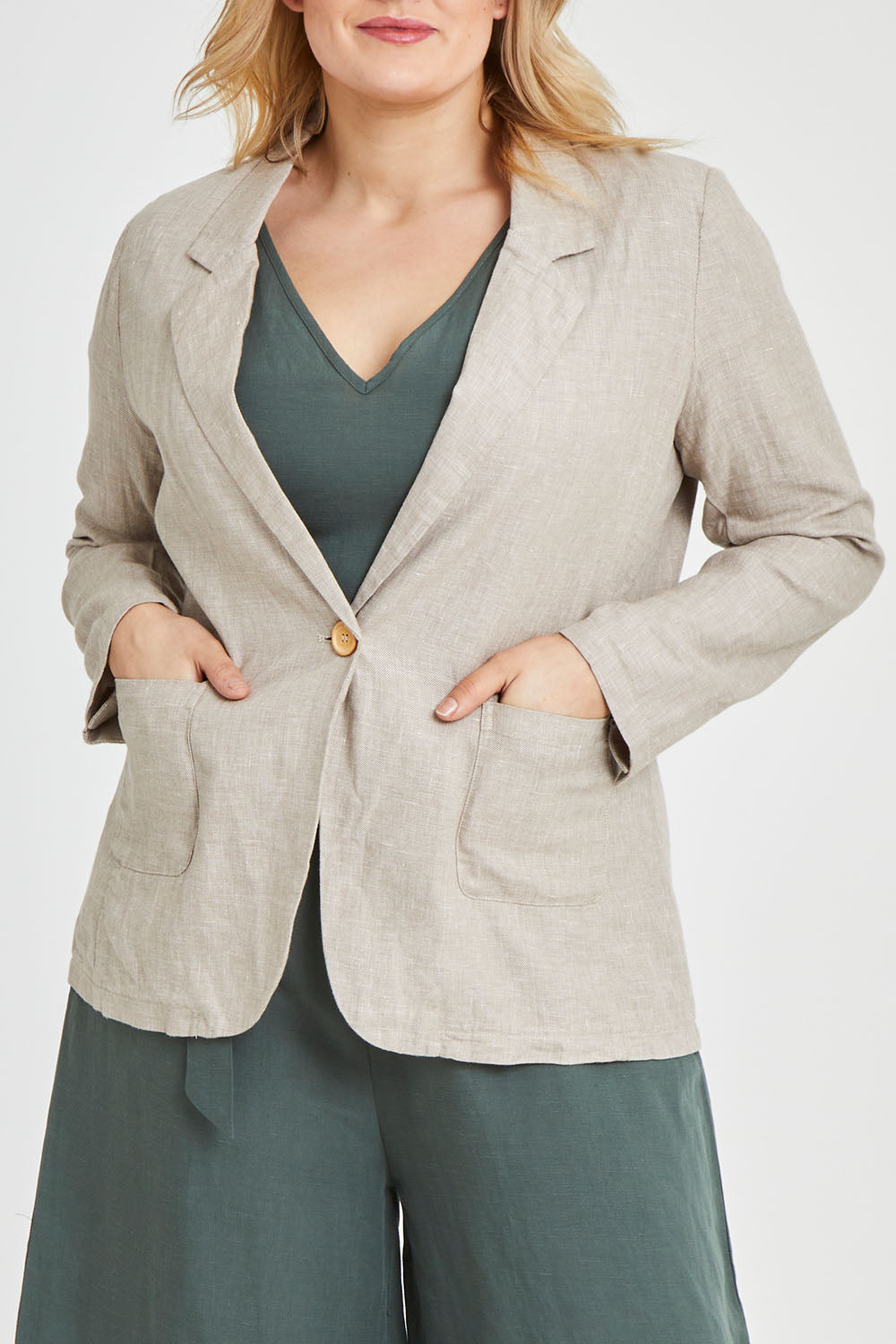 Model Keeara wearing size 16 of the Cotton Linen Longline Blazer in colour Desertsand, from the front, cropped image
