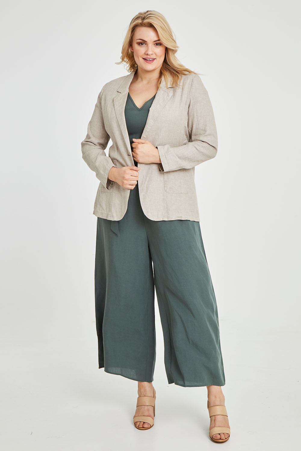 Model Keeara wearing size 16 of the Cotton Linen Longline Blazer in colour Desertsand, from the front, showing the whole outfit