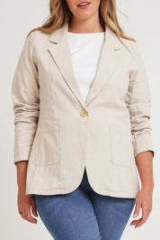 Model Chanel wearing size 16 of the Cotton Linen Longline Blazer in colour Sand, from the front, cropped image