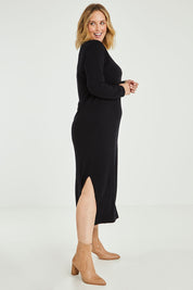 Model Jess wearing size L of the Cotton Cashmere Wool V Neck Knit Dress in colour Black (Black), from the front, showing the whole outfit