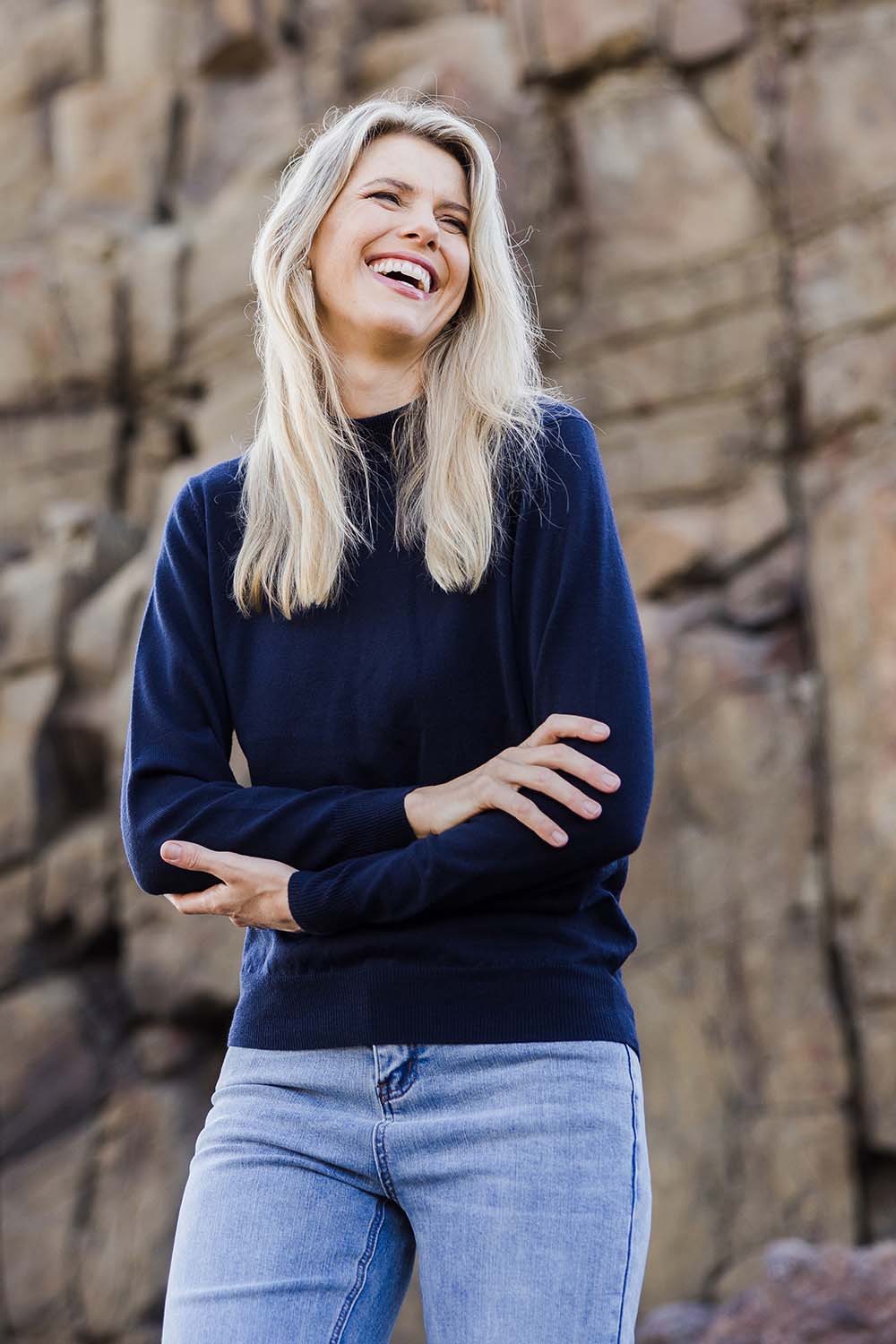 Model Kelly wearing size S of the Merino Wool High Crew Pullover in colour Navy (Blue), from the front, showing the whole outfit