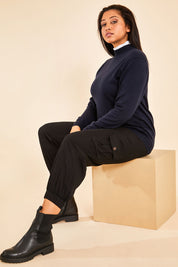 Model Terri-Leigh wearing size M of the Merino Wool High Crew Pullover in colour Navy (Blue), from the front, showing the whole outfit