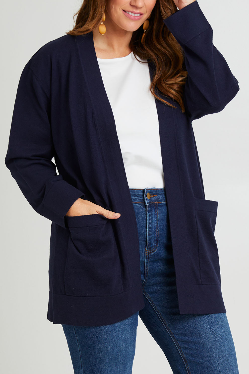 Model Laura wearing size L of the Cotton Cashmere Wool Cardigan in colour Navy (Blue), from the front, cropped image