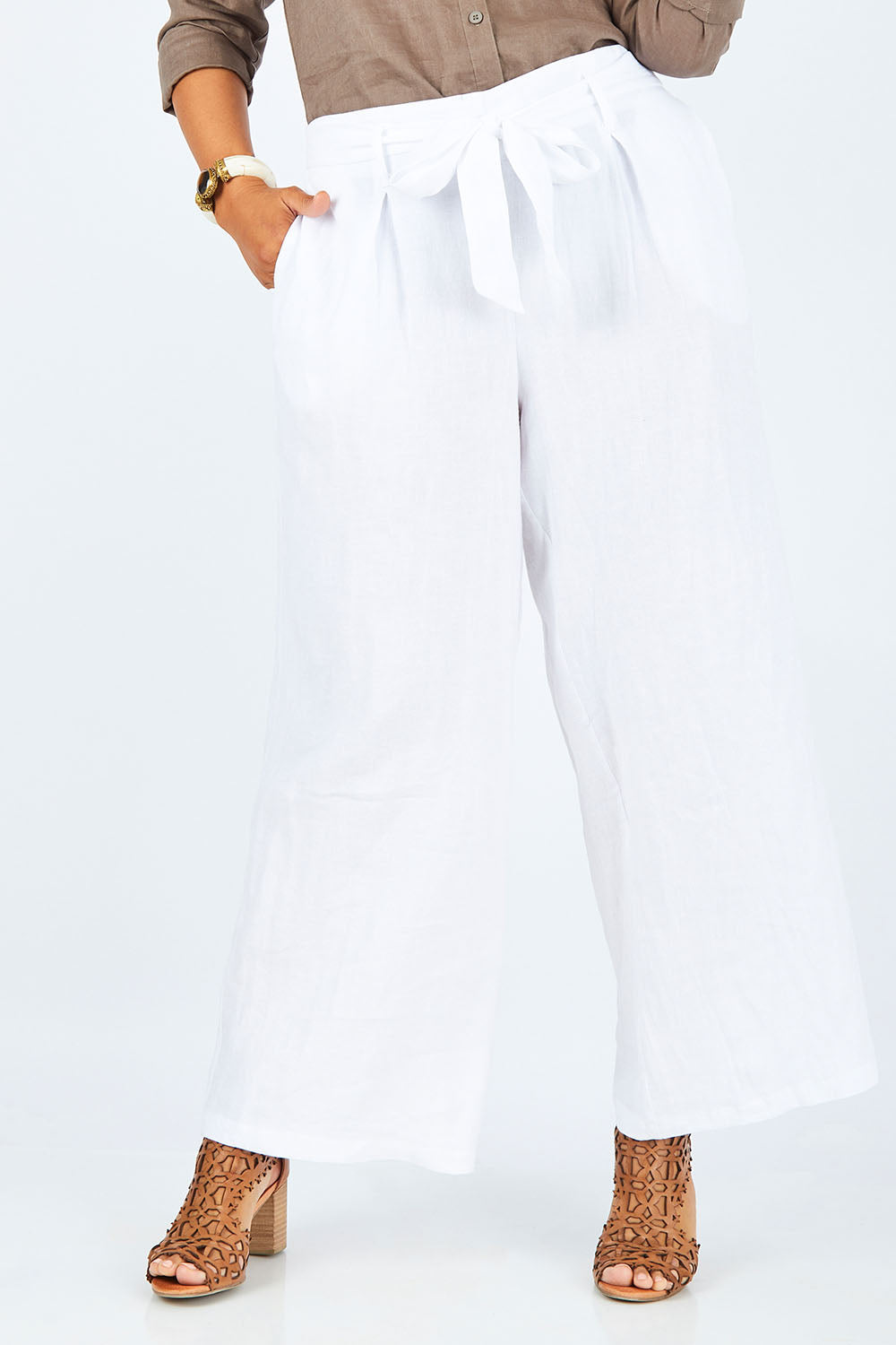 Model Palatina wearing size 14 of the Linen Long Line Pants in colour Salt (White), from the front, cropped image