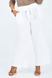 Model Palatina wearing size 14 of the Linen Long Line Pants in colour Salt (White), from the front, cropped image