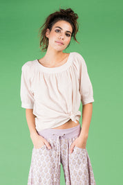 A model wearing the Bliss Top Basics in colour Mushroom, from the front, cropped image