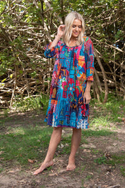 A model wearing the Organic Cotton 3/4 Sleeve Dress in colour Marared (Blue), from the front, showing the whole outfit