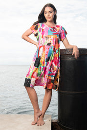 A model wearing the Alanya Short Sleeve Bubble Dress in colour Pink (Pink), from the front, showing the whole outfit