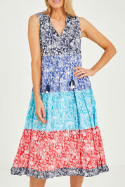 Model Kelly wearing size 10 of the Cappadocia Organic Cotton Sleeveless Dress in colour Mix (Blue), from the front, cropped image