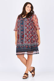 Model Mae wearing size 18 of the Urbino Print Dress in colour UrbinoPrin (Red), from the front, showing the whole outfit