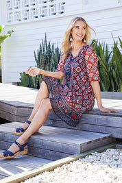 Model Phoebe wearing size 10 of the Urbino Print Dress in colour UrbinoPrin (Red), from the front, showing the whole outfit