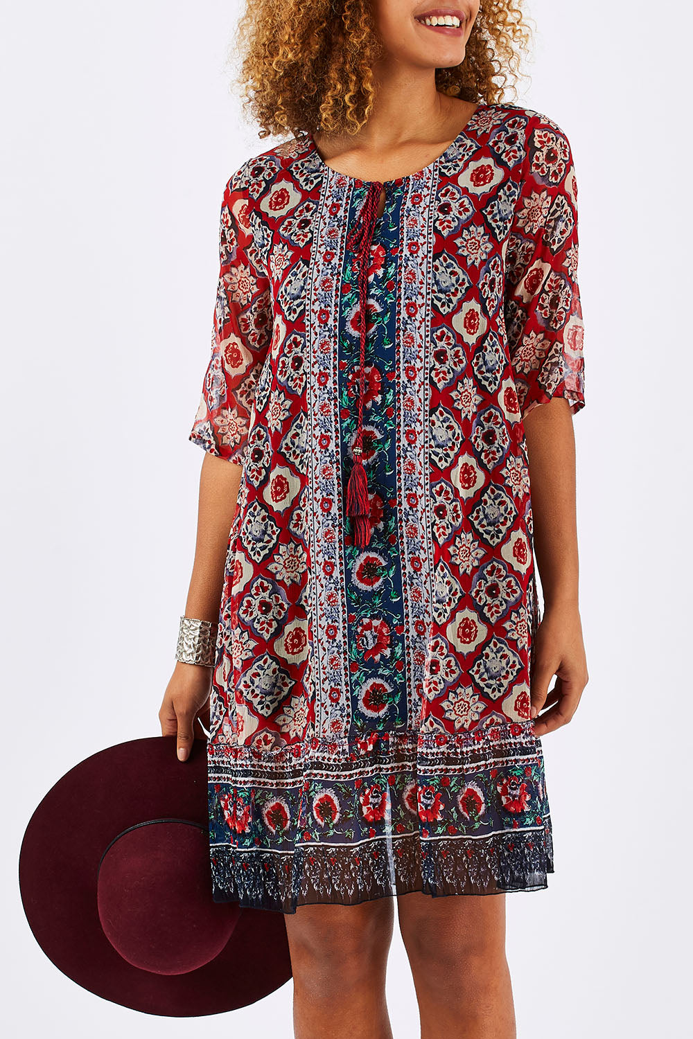 Model Summer wearing size 10 of the Urbino Print Dress in colour UrbinoPrin (Red), from the front, cropped image