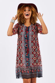Model Summer wearing size 10 of the Urbino Print Dress in colour UrbinoPrin (Red), from the front, cropped image
