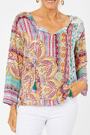 Model Rachel wearing size 10 of the Chateau Print Top in colour Print (Red), from the front, cropped image