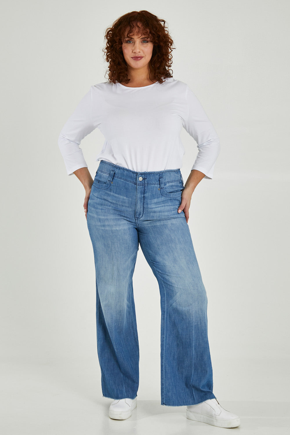 Model Maddy wearing the Higher Rise Teresa Wide Leg in colour Everly (Blue), from the front, showing the whole outfit