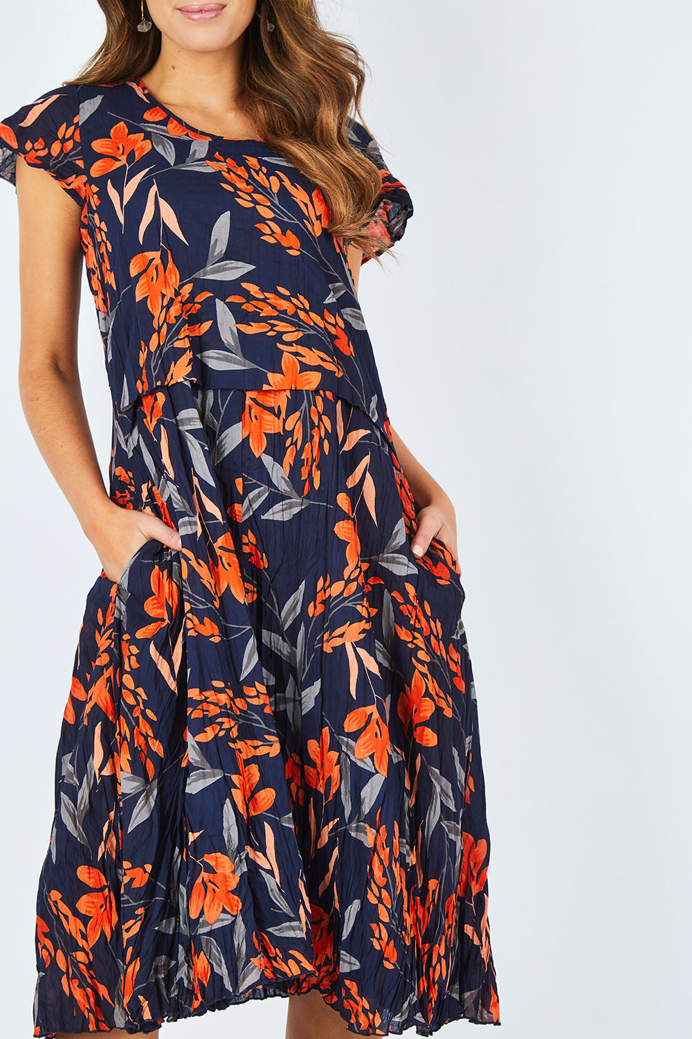 Model Madeline wearing size S of the Layer Dress in colour Floral (Blue), from the front, cropped image