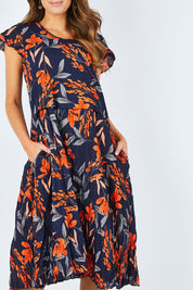 Model Madeline wearing size S of the Layer Dress in colour Floral (Blue), from the front, cropped image
