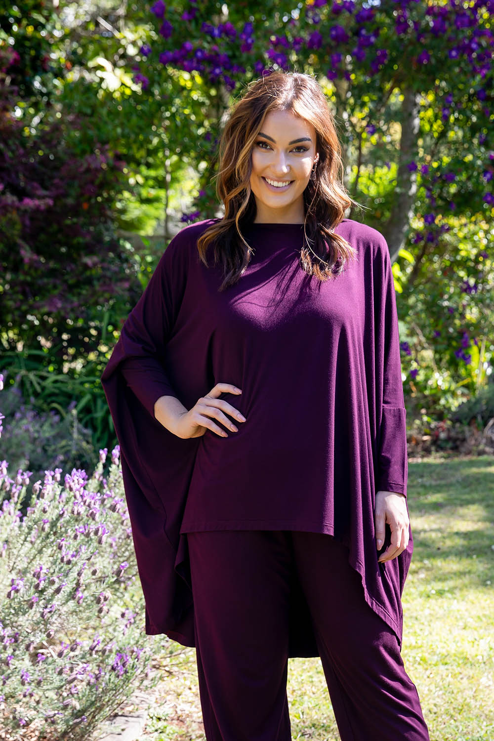 A model wearing the Jessica Top in colour Berry (Purple), from the front, showing the whole outfit