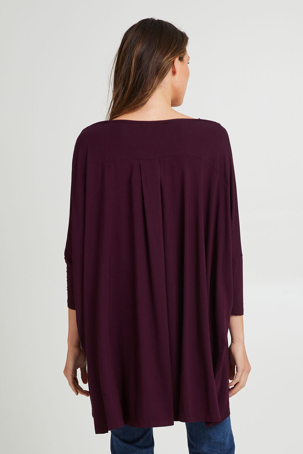 Model Madeline wearing the Jessica Top in colour Berry (Purple), from the back