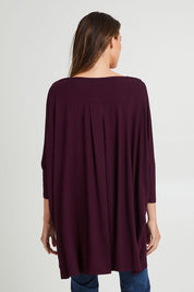Model Madeline wearing the Jessica Top in colour Berry (Purple), from the back