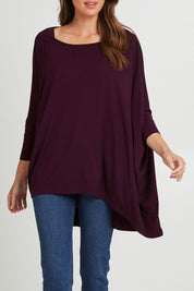 Model Madeline wearing the Jessica Top in colour Berry (Purple), from the front, cropped image