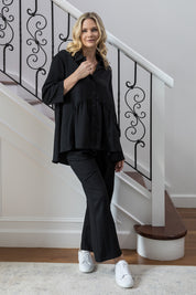 A model wearing the Wide Leg Olivia Pant in colour Black (Black), from the front, showing the whole outfit