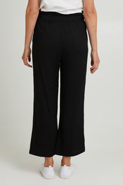 Model Madeline wearing size S of the Wide Leg Olivia Pant in colour Black (Black), from the back