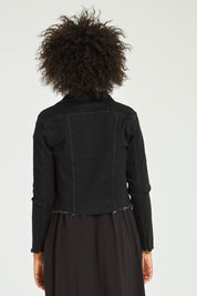 Model Olivia wearing size S of the Denim Jacket in colour Black (Black), from the back