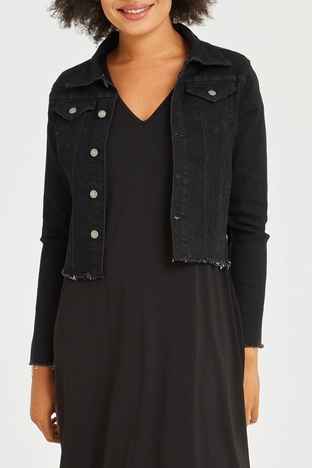 Model Olivia wearing size S of the Denim Jacket in colour Black (Black), from the front, cropped image