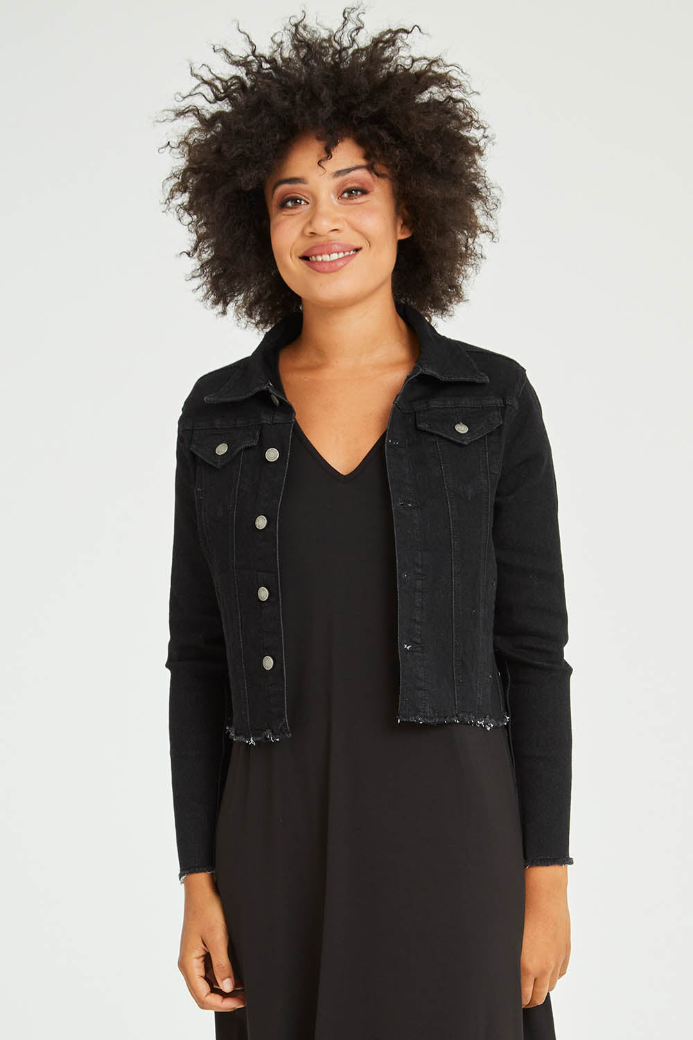 Model Olivia wearing size S of the Denim Jacket in colour Black (Black), from the front, cropped image