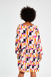 Model Olivia wearing the Sunset Gingham Tie Front Midi Dress in colour Gingham (Pink), from the back