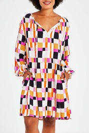 Model Olivia wearing the Sunset Gingham Tie Front Midi Dress in colour Gingham (Pink), from the front, cropped image