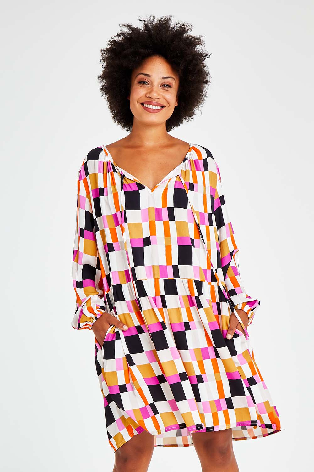 Model Olivia wearing the Sunset Gingham Tie Front Midi Dress in colour Gingham (Pink), from the front, cropped image